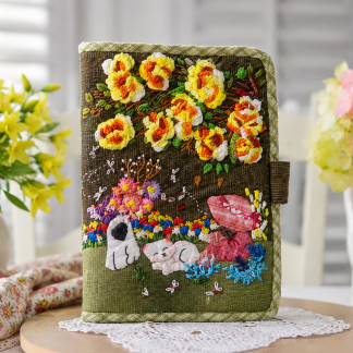 Handmade appliqué tablet and notebook cover featuring floral embroidery, cottage-style design, and soft padded protection.