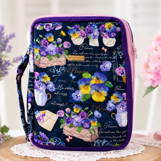 Handmade floral tablet and notebook cover featuring purple pansy flower design and quilted padded protection.