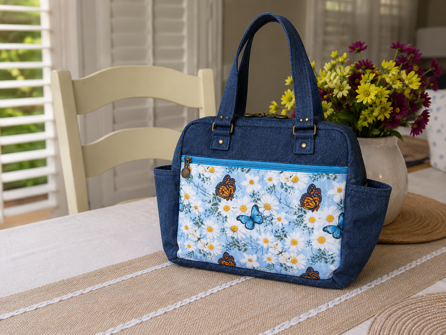 Handmade butterfly quilted shoulder bag with floral fabric, front zipper pocket, and double zipper top closure