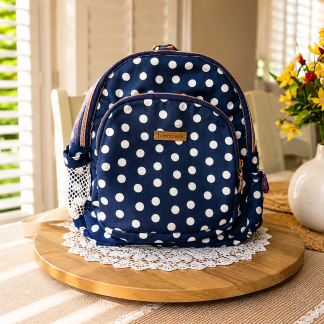 Handmade navy blue polka dot mini backpack with quilted fabric, zipper compartments, side pockets, and boutique-style design.