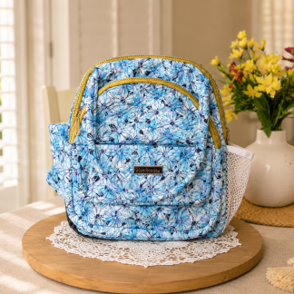 Handmade blue floral mini backpack with quilted fabric, zipper compartments, side pockets, and boutique-style design.