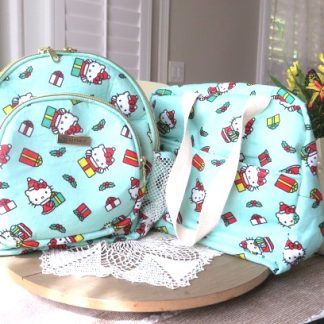 Handmade matching backpack and shoulder bag set in coordinating fabric displayed together on a table.