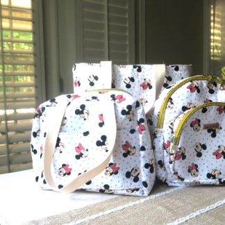 Handmade 3-piece matching bag set featuring a tote bag, shoulder bag, and backpack displayed together on a table.