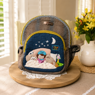 Handmade bedtime story mini backpack with cozy appliqué artwork, quilted fabric, zipper compartments, and boutique-style design.