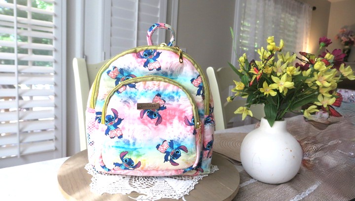 Handmade floral mini backpack featuring quilted fabric, boutique-style craftsmanship, and practical everyday storage.