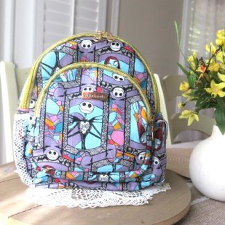 Handmade whimsical story mini backpack with colorful character artwork, quilted fabric, zipper compartments, side pockets, and boutique-style design.