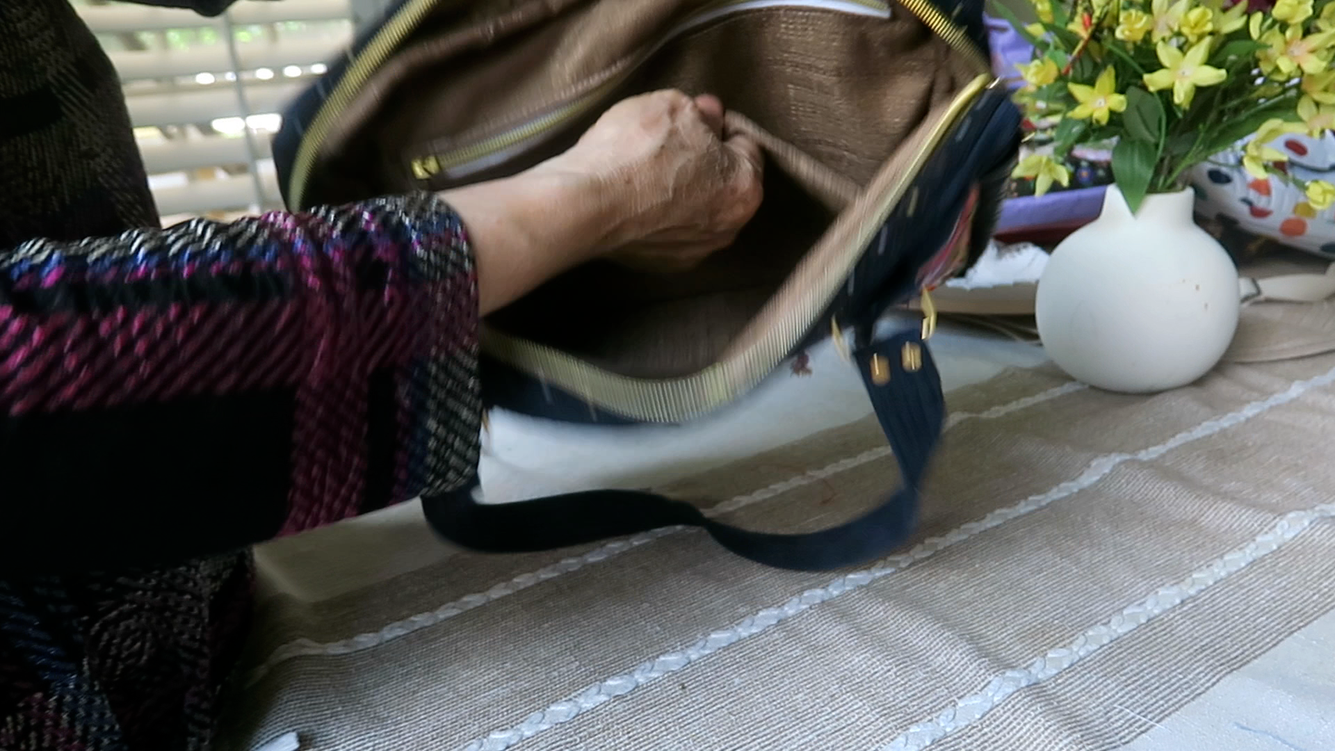 Interior view of handmade floral shoulder bag showing storage pocket and spacious compartment for iPad and notebooks.