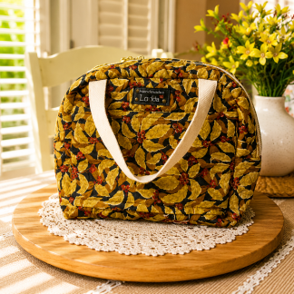 Handmade autumn leaf quilted lunch tote with waterproof interior and soft cotton handles