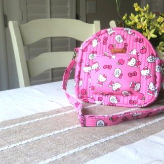 Handmade colorful bright pink shoulder bag with adjustable strap and quilted cotton design”