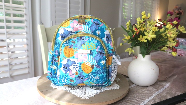 Handmade floral mini backpack featuring quilted fabric, boutique-style craftsmanship, and practical everyday storage.