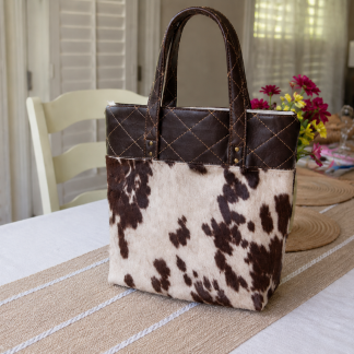 Handmade western suede tote bag with cowhide-inspired design and quilted shoulder straps