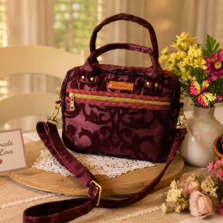 Handmade burgundy floral Shoulder Bag and Handbag Combo with adjustable shoulder strap and front zipper pocket displayed on a decorative wooden tray with flowers.