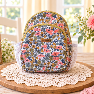 Handmade coral floral backpack with gold-tone zippers, front compartment, and side pockets